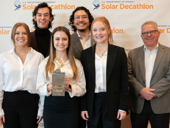 Group of CAPLA students and David Brubaker posing with their Solar Decathlon Design Award. 