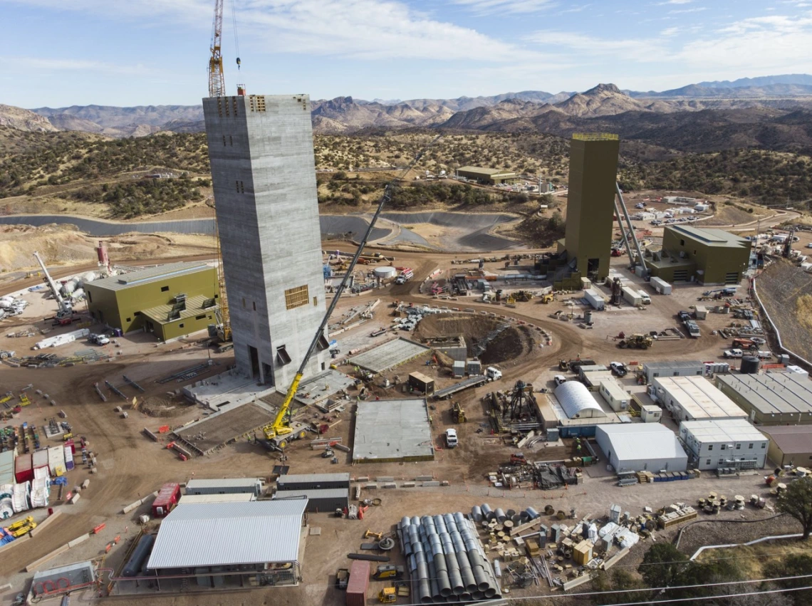 Construction equipment and vehicles surround a mining facility. 