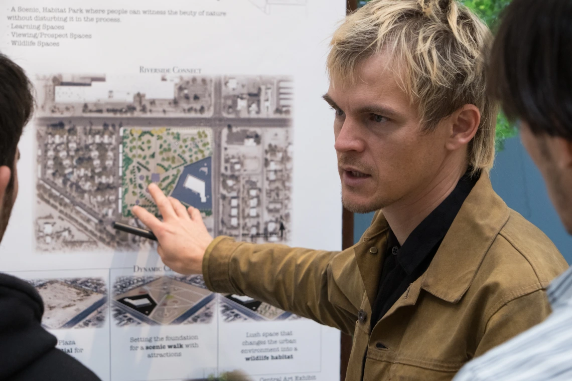 Student pointing to an illustration of a park. 